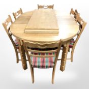 A Danish blond oak extending dining table with three leaves and six dining chairs in striped
