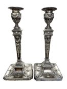 A pair of Edwardian Neo-Classical loaded-silver candlesticks with matching removable sconces,