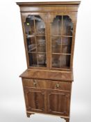 A reproduction mahogany bookcase, 76cm wide x 43cm deep x 174cm high.