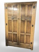 A Fyne Ladye carved oak double door wardrobe,