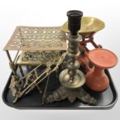 Two brass trivets, an ornate lamp vase, pair of easel stands and a set of enamelled scales.