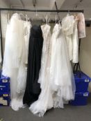 A rail of fourteen various pieces of bridal wear, lady's black evening dress,