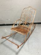 A weathered wrought metal garden rocking seat