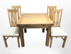 A modern oak pull out extending dining table,