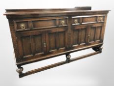 An Edwardian panelled oak sideboard,