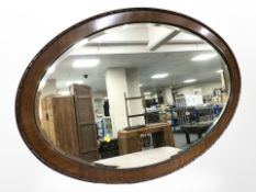 A Victorian carved mahogany oval mirror,