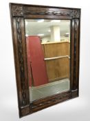 An Edwardian carved oak wall mirror, length 71cm.
