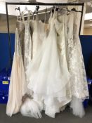 A rail of twelve wedding dresses, sizes 8 - 16,