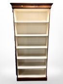 A reproduction painted open bookcase,