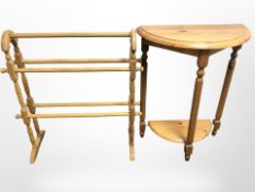 A modern pine demi lune table and a towel rack