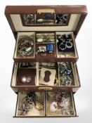 A multi-compartment jewellery box containing assorted costume jewellery,