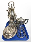 An ornate silver-plated spirit kettle on burner, lidded entrée dish, toast rack,