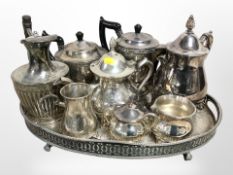 A silver-plated gallery tray containing assorted tea wares.