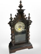 A 19th-century Junghans mantel clock in carved beech case, with pendulum and key, height 53cm.