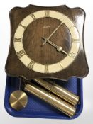 A Junghans wall clock with pendulum and weights.