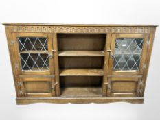 An oak leaded glass bookcase,