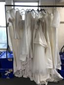 A rail of twelve wedding dresses, nearly all size 12,
