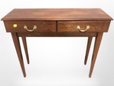 A reproduction mahogany two drawer side table,