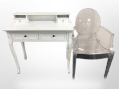 A modern white dressing table and plastic ghost chair
