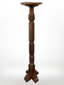 A reproduction carved mahogany torchere,