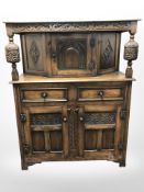 A reproduction carved oak court cupboard,