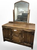 A Fyne Ladye carved oak mirror backed dressing table,