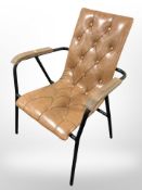A modern Scandinavian tan vinyl armchair