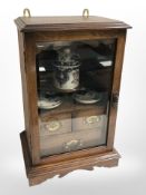 A late-Victorian glazed oak smoker's cabinet, height 43cm.