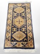 A machined rug of Caucasian design on indigo ground,