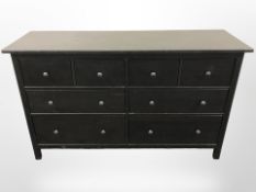 A contemporary stained pine eight drawer chest,