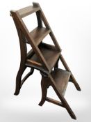 A reproduction hardwood folding metamorphic library step chair