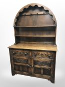 A carved oak dome topped dresser,
