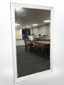 A large white painted floor standing mirror,
