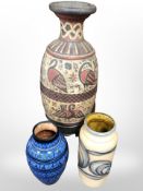 A painted terracotta vase on metal stand, height 84cm,