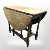 An oak drop leaf dining table,