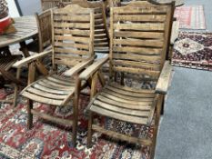 A pair of plantation teak folding armchairs, width 63cm.