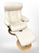 A contemporary laminated wood and cream leather swivel armchair