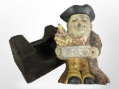 A Fifty-six pound cast iron weight and a cast iron door stop