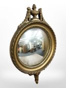A reproduction gilt convex mirror,
