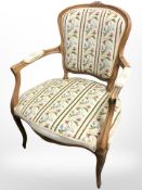 A carved beech salon armchair in tapestry fabric