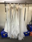 A rail of twelve wedding dresses, nearly all size 12,