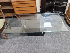 A contemporary black marble and glass pedestal coffee table,