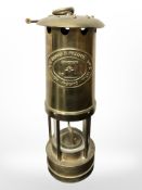 An E Thomas & Williams Limited brass miner's lamp.