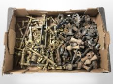 A quantity of antique brass door handles and door furniture, turned wooden examples, etc.