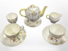 A Paragon tea for two hand-painted with flowers, numbered X2124.