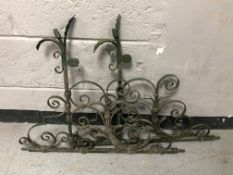 A pair of painted wrought iron wall brackets,