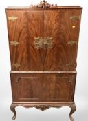 A carved mahogany cocktail cabinet,