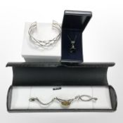 A silver Celtic-style bangle, a further silver and Baltic amber bracelet, and a pendant.