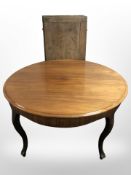 A continental circular mahogany dining table and three leaves