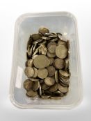 A tub containing a collection of nickel-brass coins, in the main threepence bits and others,